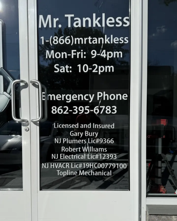The Mr. Tankless shop door listing its licenses: Gary Bury, NJ Plumbers License #9366; Robert Williams, NJ Electrical License #12393; Topline Mechanical, NJ HVACR License #19HC00779100